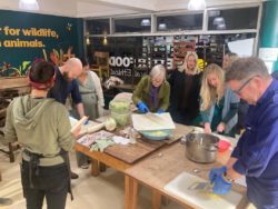 Group of people in cafe making kimchi